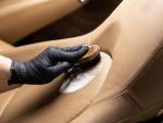 Cleaning leather car seat and upholstery with brush. Car detailing
