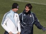 Los jugadores del Real Madrid Guti (i) y Granero charlan al comienzo del entrenamiento.