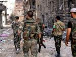 Soldados sirios patrullando una calle en Alepo (Siria).