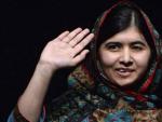 La paquistan&iacute; Malala, Nobel de la Paz 2014, saluda en la biblioteca del colegio de Birmingham en el que estudia.
