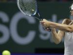 La tenista rusa Maria Sharapova devuelve la bola a la polaca Agnieszka Radwanska durante su partido del Masters femenino de Singapur 2014.