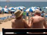 Dos ancianos toman el sol en la playa.