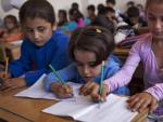 Ni&ntilde;os sirios durante una clase de primaria en un colegio del distrito de Saif Al-Dawla, en Alepo (Siria). El Fondo de las Naciones Unidas para la Infancia (Unicef) ha instado a aumentar los esfuerzos para que la ayuda humanitaria llegue a los cientos de miles de ni&ntilde;os atrapados por el conflicto.