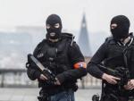 Polic&iacute;as enmascarados vigilan en Bruselas.