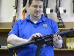 Un propietario de una armer&iacute;a sostiene un rifle semiautom&aacute;tico de asalto MP15 de la firma Smith &amp; Wesson en su negocio en Tucker (Georgia, EE UU)