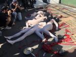 Manifestantes desnudos con los cuerpos pintados de blanco portan carteles con los nombres de los fallecidos en las protestas de Chile, en Santiago.