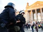 La polic&iacute;a alemana detiene a un manifestante en la Puerta de Brandenburgo, en Berl&iacute;n.