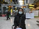 Una joven muestra el resultado de su PCR a su llegada al aeropuerto Adolfo Su&aacute;rez-Barajas en Madrid, este lunes, donde comienza la exigencia de pruebas PCR para pasajeros de vuelos procedentes de pa&iacute;ses de riesgo.