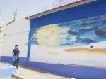 El artista Carlos Ala&ntilde;on realizando el mural que est&aacute; haciendo en Aldea del Rey