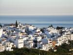 Beautiful townscape of Frigiliana, white houses village in M&aacute;laga, Andaluc&iacute;a, Spain, in the evening light. Mediterranean seascape in the background.