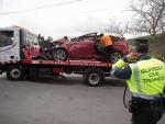 Un Guardia Civil vigila la retirada del coche siniestrado, en el accidente, por una gr&uacute;a, a 1 de abril de 2023, en Xove, Lugo,