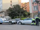 La grúa municipal retira un coche en Oviedo.