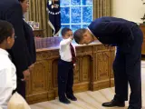 Obama se deja tocar el pelo por un niño en el Despacho Oval.