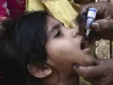 Una niña recibe una dosis oral de vacuna contra la polio en Karachi, Pakistán. La campaña contra la polio en Pakistán comenzó en 1994 y su avance chocó con la desconfianza de muchos paquistaníes que creen que vacunar es antislámico, provoca infertilidad o es una operación de Occidente para acabar con los musulmanes.