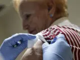 Una mujer recibe una dosis de la vacuna de la gripe a una paciente esta ma&ntilde;ana en el Centro de Salud Fuente San Luis (Valencia), en el inicio de la campa&ntilde;a de vacunaci&oacute;n contra la gripe.
