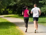 Rear view of Caucasian female and male runners outdoors