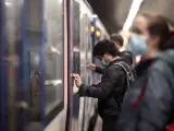 Viajeros tomando em Metro en Madrid