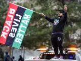 Una persona celebra con una bandera del movimiento Black Lives Matter el veredicto del jurado que declaró culpable de la muerte de George Floyd al expolicía Derek Chauvin, en Mineápolis (Minesota, EEUU).
