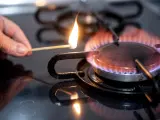Una persona enciende un fuego en una cocina de gas.