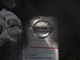 El emblema de Nissan rodeado de humo por una quema de neumáticos de los trabajadores.