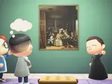 La guía enseñando 'Las meninas' a unos visitantes en el 'Animal Crossing'.