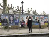 Una mujer mira los carteles de los candidatos a las elecciones presidenciales de Francia en Bordeaux.
