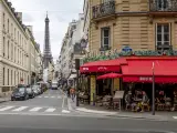 Paris, France - May 20, 2021: Day after lockdown due to covid-19 in a famous Parisian cafe with Eiffel tower in background in Paris