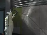 Un operario municipal eliminando un grafiti en Barcelona.