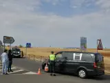 Un furgón de la Guardia Civil y un coche fúnebre en la carretera de Argamasilla de Calatrava