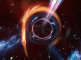 Un agujero negro supermasivo lanzando chorros mientras consume una estrella cercana.