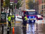 Los bomberos evacúan una balsa de agua en Barcelona.