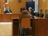 El presunto traficante, de espaldas, responde a las preguntas del fiscal durante el juicio.