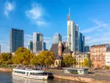 Cityscape skyline of business district with skyscrapers and cruise ship during sunny day in Frankfurt am Main. Hessen, Germany.