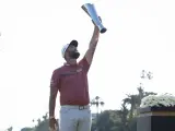 Jon Rahm levanta el trofeo del Genesis Invitational para celebrar su victoria.