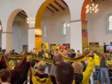Los aficionados del Borussia Dortmund congregados en la iglesia.