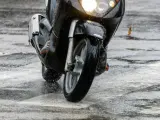 Una moto circulando con temporal de lluvia.