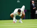 Novak Djokovic soplando el césped de Wimbledon.