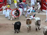 Un mozo es cogido por uno de los toros de Fuente Ymbro en su entrada a la plaza de toros de Pamplona.