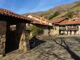 BARCENA MAYOR, SPAIN - JANUARY 16, 2022: Beautiful village of Barcena Mayor with the traditional stone houses in the Cantabria mountains in a sunny day. Cantabria, Spain.