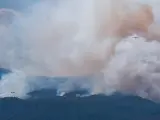 Dos hidroaviones descargan agua sobre el incendio forestal que afecta a la isla de Tenerife este lunes en Güimar, uno de los municipios afectados.