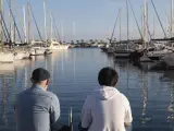 Adopted father and son looking at view on port