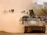 Tropas israelíes en vehículos blindados de transporte de tropas patrullan a lo largo de la frontera entre Israel y Gaza.