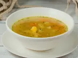 a bowl of chicken soup with potato, carrot and dill served with bread slices