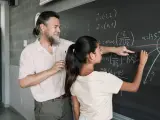 Profesor enseñando Matemáticas a una alumna.