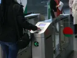 Una usuaria del metro de Granada pagando la tarifa de acceso con la tarjeta.