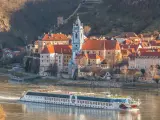 Durnstein village during spring time with tourist ship on Danube river in Wachau (UNESCO), Austria