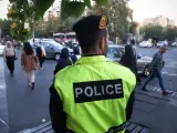 Un agente de la Policía observa a el paso de mujeres en Teherán.