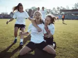 Close up of a female soccer team celebrating a scored goal