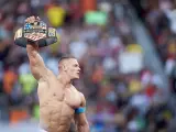 John Cena levanta su cintur&oacute;n del campe&oacute;n del mundo de la WWE en WrestleMania 31.
