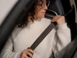 Una conductora se abrocha su cinturón de seguridad.
